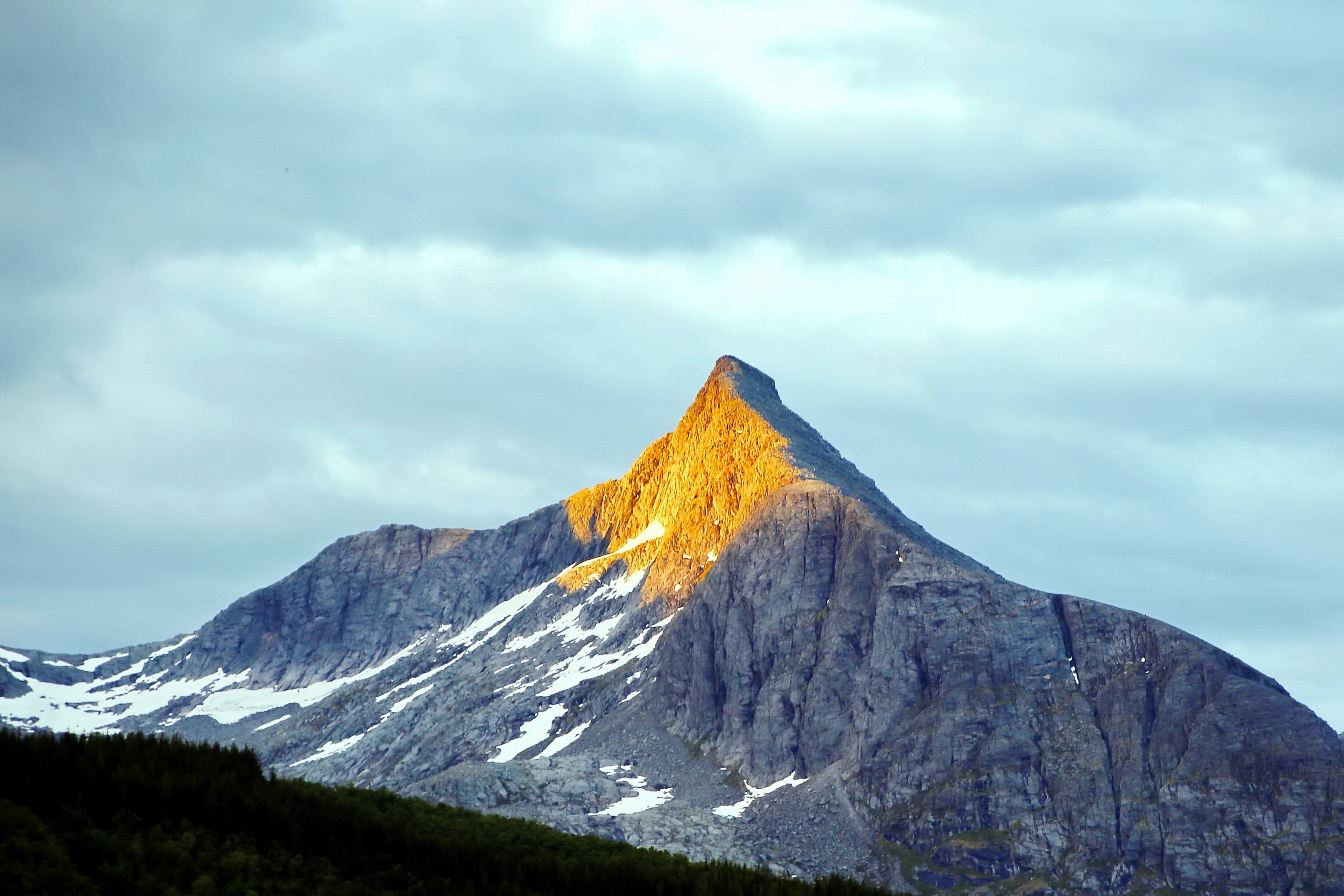 Mountain peak illuminated by golden light
